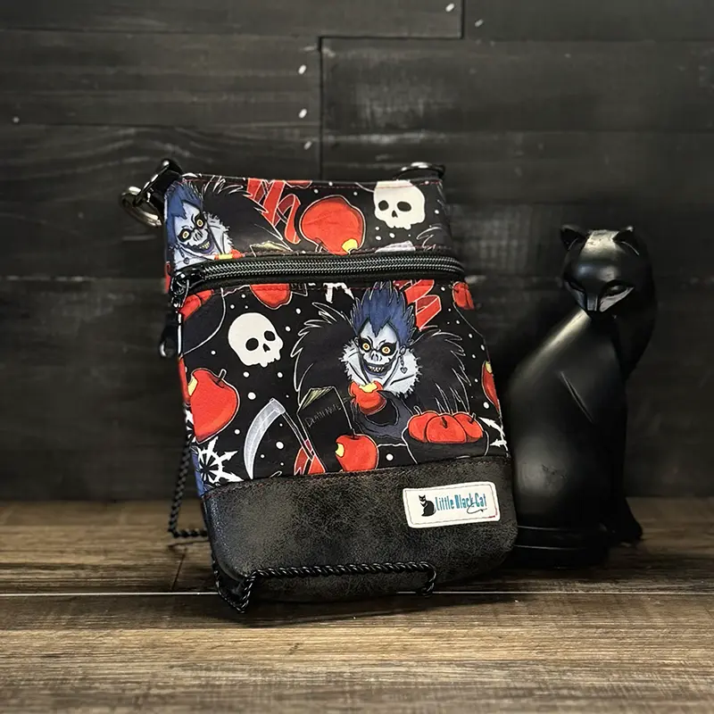 small crossbody phone bag with a wolf design in blue