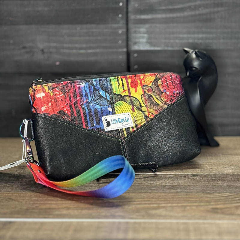 handmade wristlet featuring stylized rainbow flowers accented with black sparkle vinyl