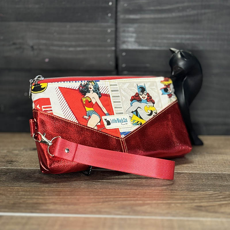 handmade wristlet featuring super women designs in red, white, blue, and yellow with metallic red vinyl accents