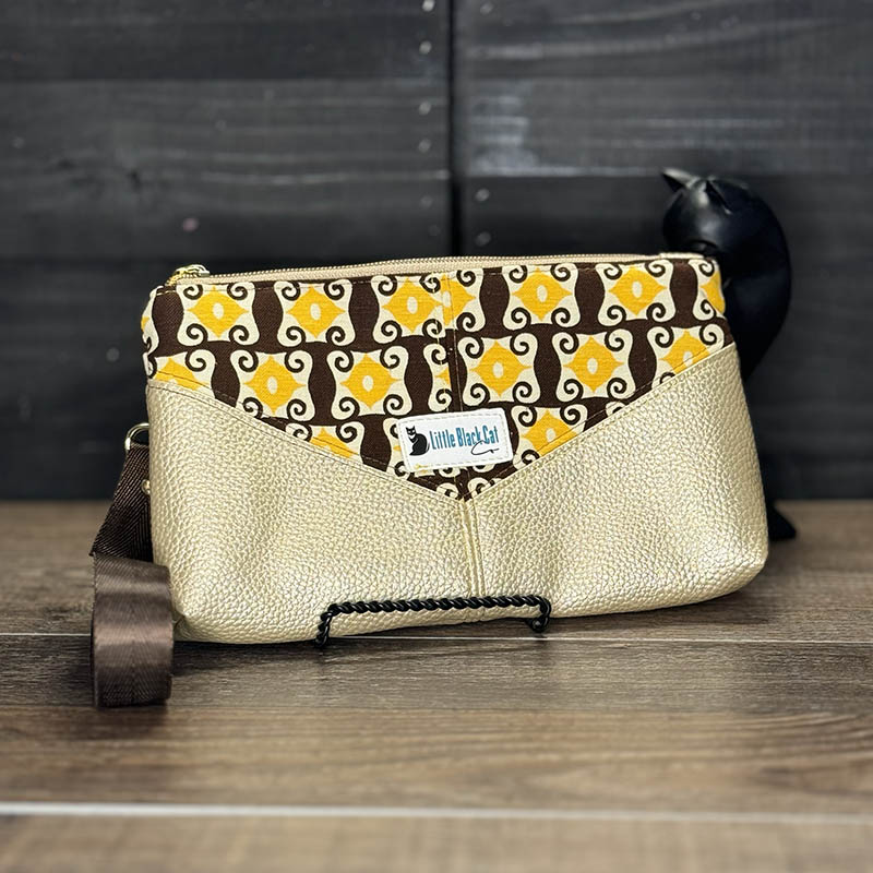 handmade wristlet featuring vintage 70s fabric with a brown and yellow design