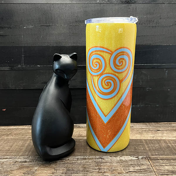 decorated 20oz steel tumbler with yellow and orange glitter decoration and blue vinyl swirls